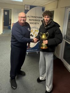 Steve Johnson presenting the trophy to Sam Fletcher